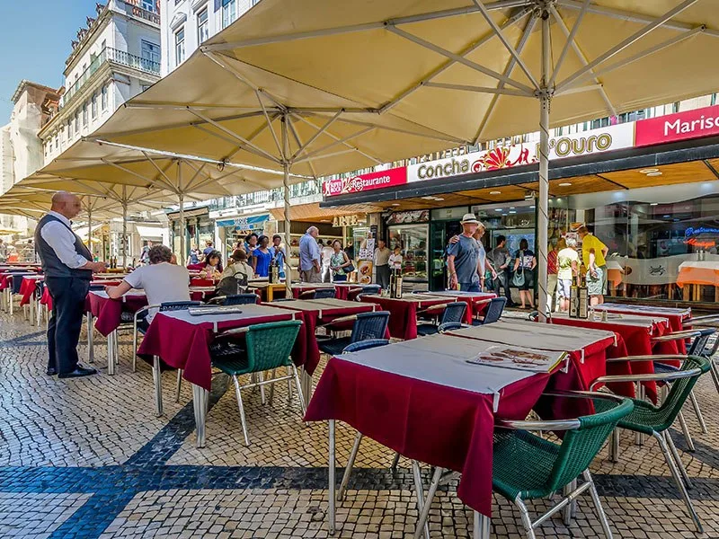 Outdoor dining tables on a Lisbon street